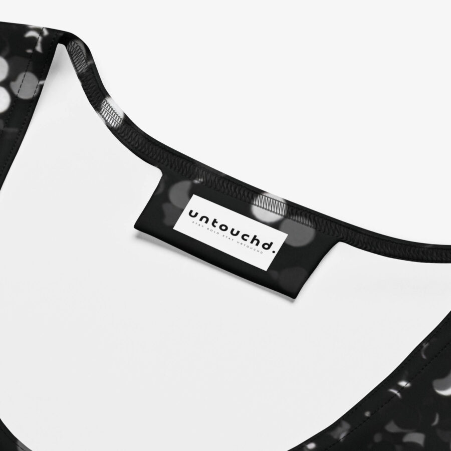 Close-up of the inside neckline of the dress showing the "untouchd." brand label on the black and white bokeh print fabric.