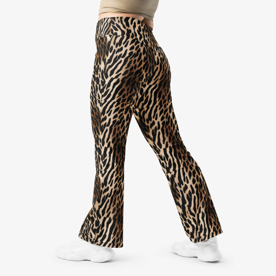 Close-up side view of Wild Charm Leopard Flare Leggings showing the bold animal print while walking in white sneakers.