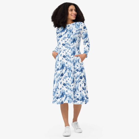 Woman smiling in the Blue Floral Long Sleeve Midi Dress with hands in side pockets, styled casually with white sneakers