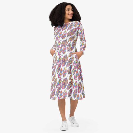 Woman smiling while twirling in a feather print midi dress, revealing the side silhouette and movement of the fabric.