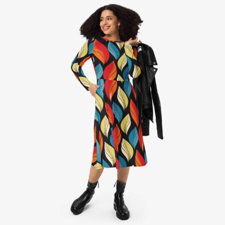 Woman styling the Harvest Drift Midi Dress with black ankle boots and a leather jacket, showcasing the bold leaf print in red, blue, yellow, and cream.