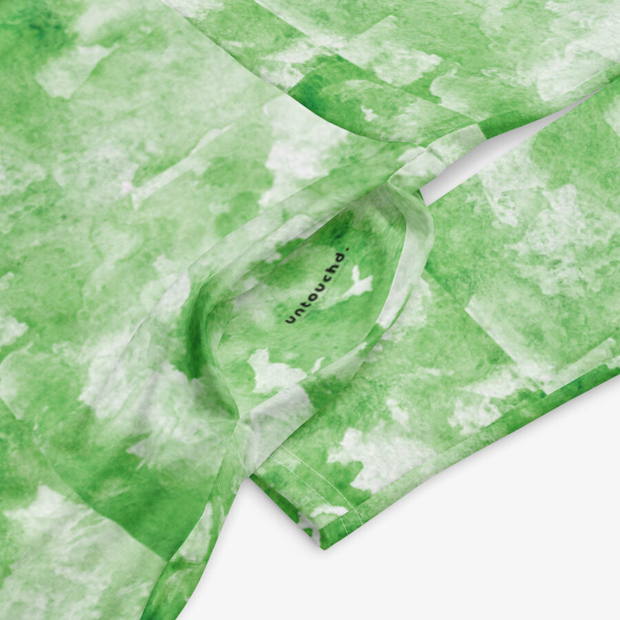 Close-up of the inner label inside the green cloud-patterned midi dress, showing the ‘untouchd.’ branding.