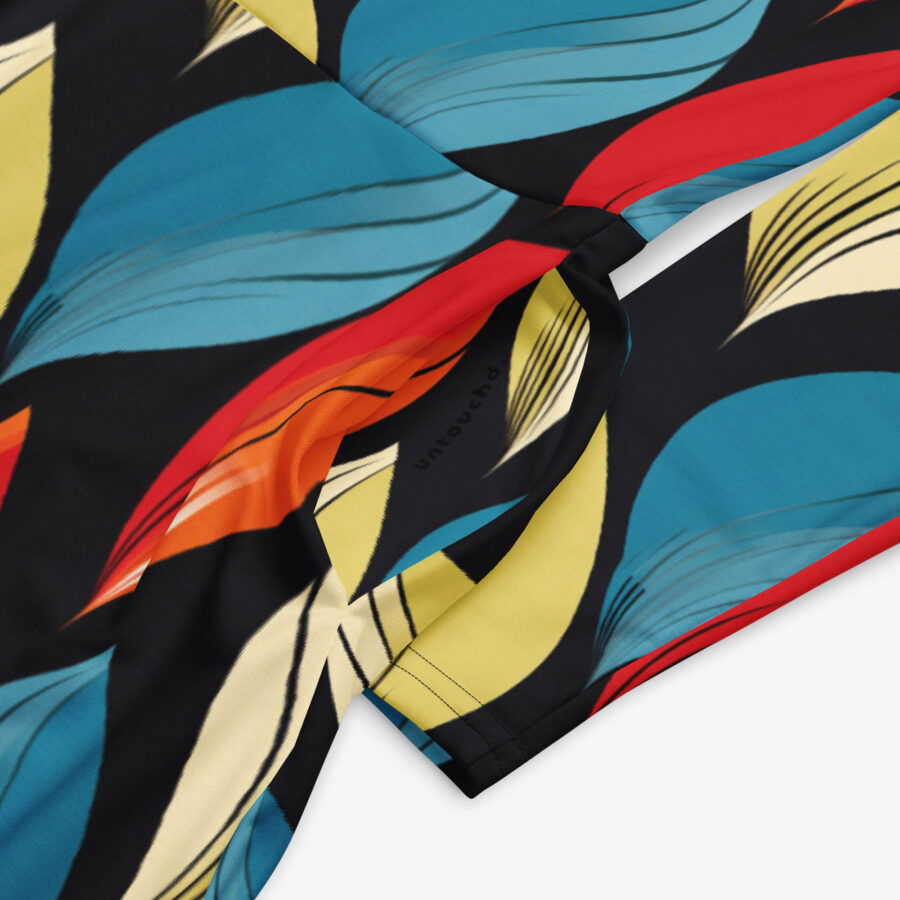 Close-up of the Harvest Drift Midi Dress fabric showing intricate leaf design details and the “untouchd” branding on the inner seam.