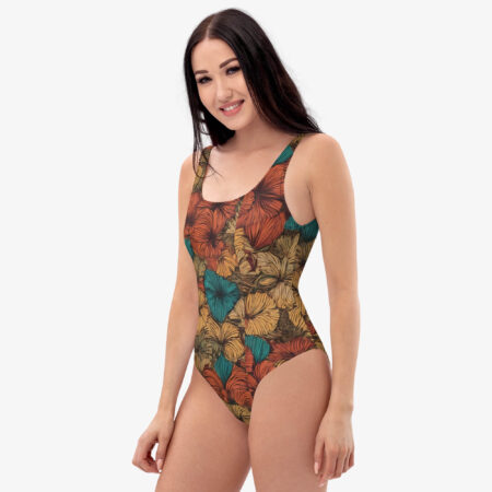 Model slightly turned to the side wearing the Amber Tropic Bloom Swimsuit, showing the pattern wrapping around the body.