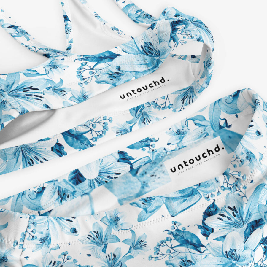 Close-up detail of the Azure Bloom High Waisted Bikini’s interior tags showing the "untouchd." branding against the crisp floral fabric.