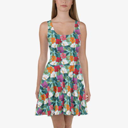 Front view of a model in a floral skater dress with a fitted bodice and flared skirt, featuring multicolored tropical blooms and white leaves.