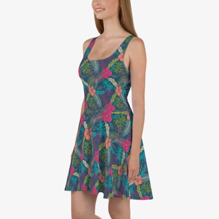 Smiling woman in a sleeveless A-line dress featuring an all-over tropical print with vivid flowers and leafy motifs.