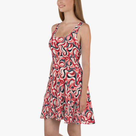 A smiling model stands in a studio wearing the Scarlet Wave Skater Dress, showcasing its fitted bodice and flared hem against a plain white background.