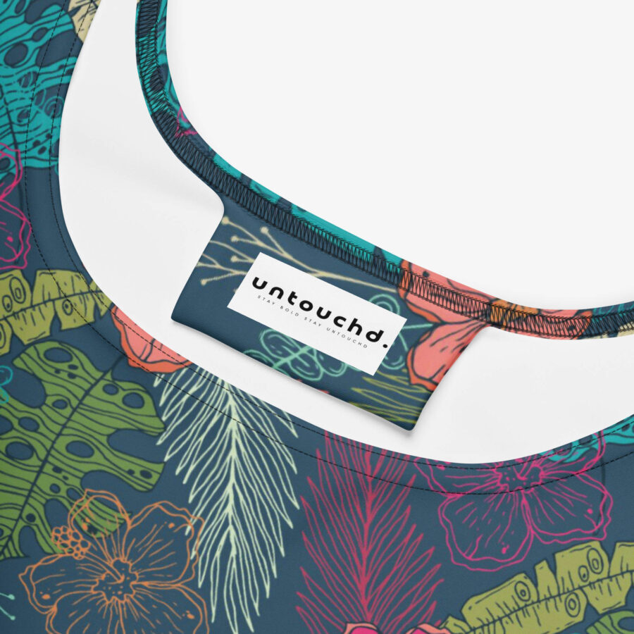 Close-up of the inner neckline of a floral dress, showcasing the Untouchd brand label against the vibrant botanical print fabric.