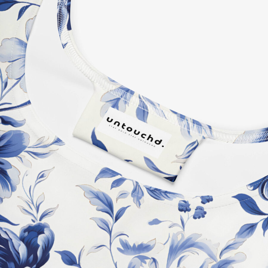 Close-up of dress neckline showing "Untouchd" brand label on blue floral print fabric.