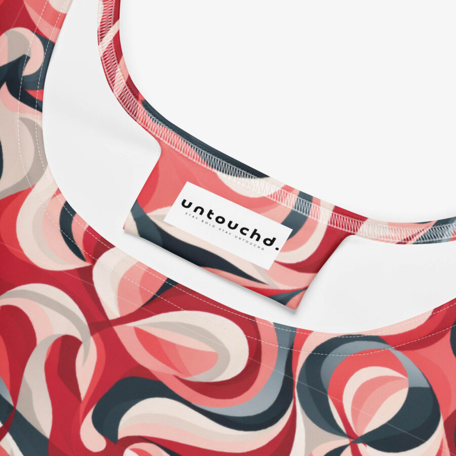 Close-up view of the inside neckline of the Scarlet Wave Skater Dress, showing the 'untouchd.' brand tag stitched against the swirling abstract pattern.