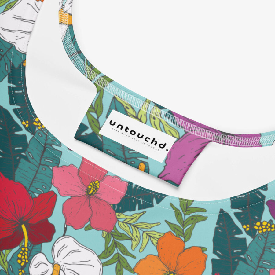 Close-up of the neckline and tag of the floral skater dress, showing the Untouchd brand label and detailed floral print on soft fabric.