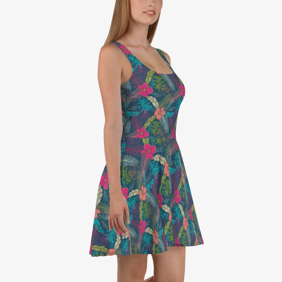 Side view of a model in a colorful skater dress with a fitted bodice and flared skirt, displaying tropical floral and leaf patterns.