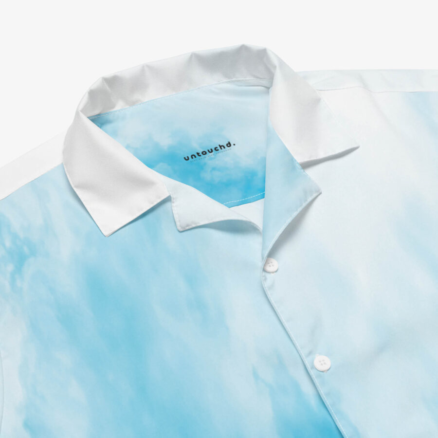 Close-up of the shirt’s collar showing the smooth blue-white cloud pattern and the “untouchd.” logo printed inside the neckline.