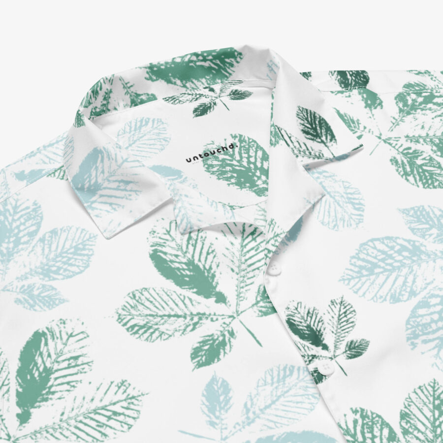Zoomed-in detail of the Mistleaf Botanical Button Shirt collar, featuring the “untouchd” branding and crisp leafy prints on smooth fabric.