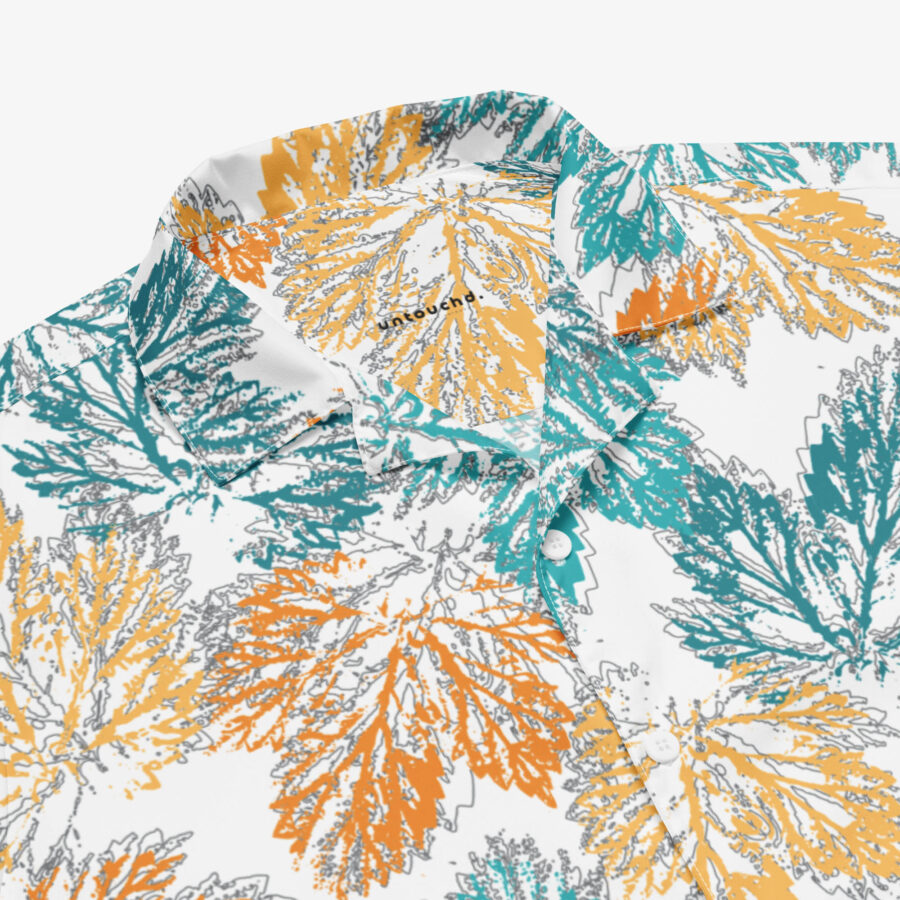 Close-up of the collar and buttons of the Autumn Mirage Button Shirt, featuring the “untouchd.” label and intricate detailing of the textured leaf pattern in warm, earthy tones.