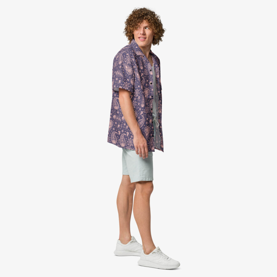 Side view of a man wearing the Paisley Bloom Button Shirt with light shorts and white shoes, looking over his shoulder.