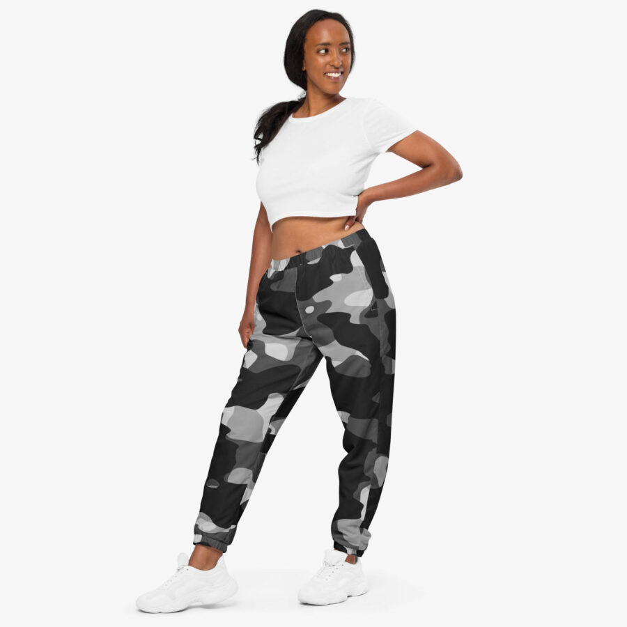 The phantom drift camo track pants fuse grayscale camo with utility details and breathable comfort, crafted for movement and everyday edge. woman view