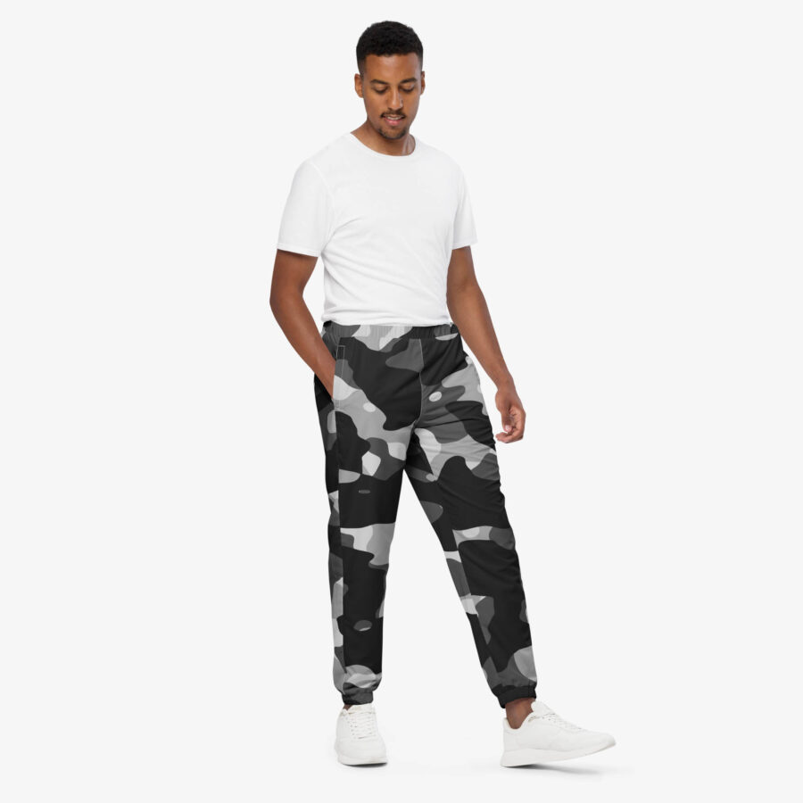 The phantom drift camo track pants fuse grayscale camo with utility details and breathable comfort, crafted for movement and everyday edge. man view